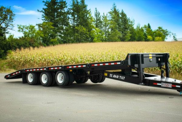 BWS tag-along trailer tilt deck lowered for easy equipment loading without ramps